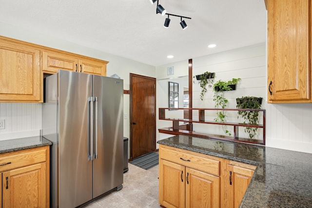 kitchen featuring recessed lighting, visible vents, track lighting, dark stone counters, and high end refrigerator