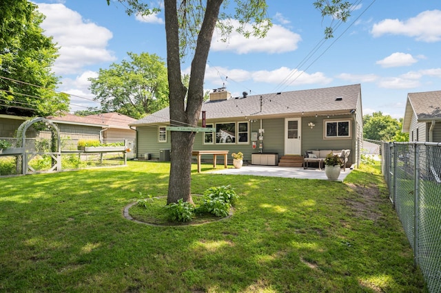 rear view of property featuring a patio, a fenced backyard, a shingled roof, a lawn, and a chimney