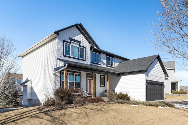 view of front of home featuring an attached garage and covered porch