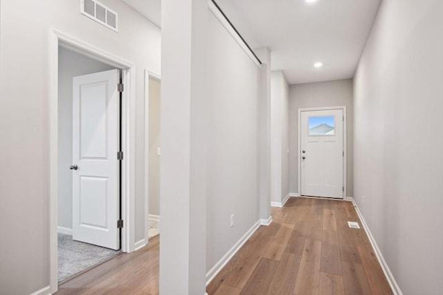 entryway featuring recessed lighting, visible vents, baseboards, and hardwood / wood-style flooring