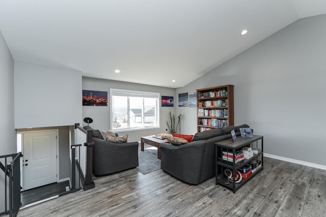 living room with lofted ceiling, recessed lighting, wood finished floors, and baseboards