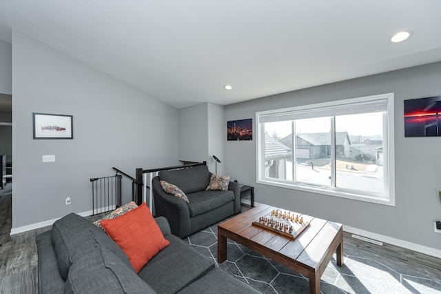 living room featuring baseboards, vaulted ceiling, wood finished floors, and recessed lighting