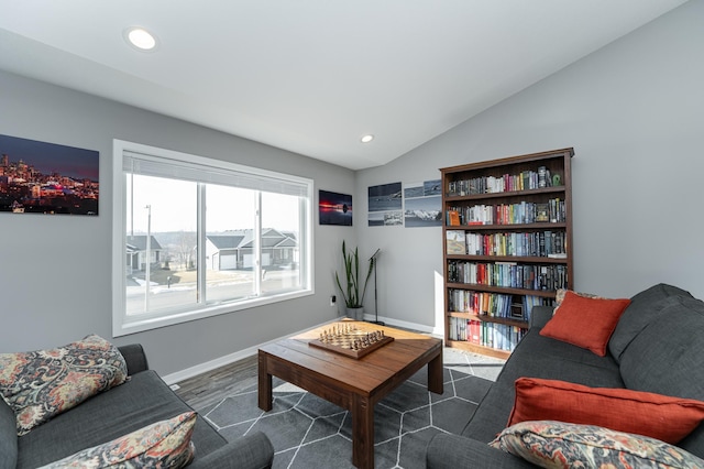 living area with lofted ceiling, recessed lighting, and baseboards