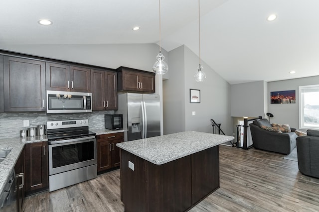 kitchen featuring lofted ceiling, stainless steel appliances, wood finished floors, open floor plan, and dark brown cabinets