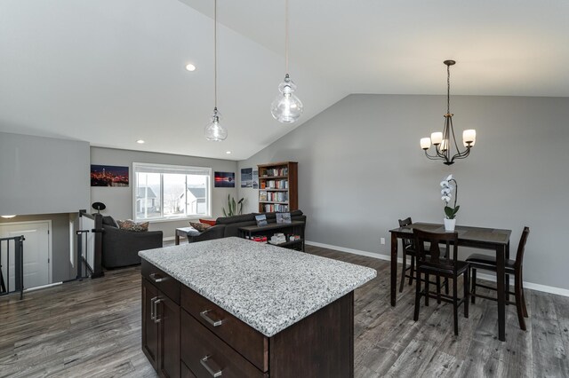 kitchen featuring lofted ceiling, baseboards, dark brown cabinets, and wood finished floors