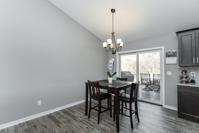 dining space with lofted ceiling, baseboards, and dark wood-type flooring