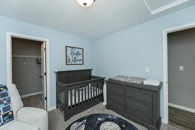 bedroom featuring a spacious closet, a closet, and baseboards