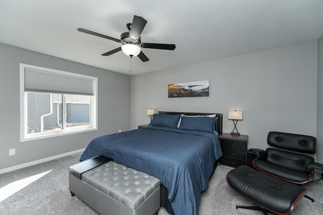 carpeted bedroom featuring baseboards and a ceiling fan