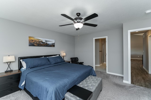 carpeted bedroom featuring a ceiling fan and baseboards