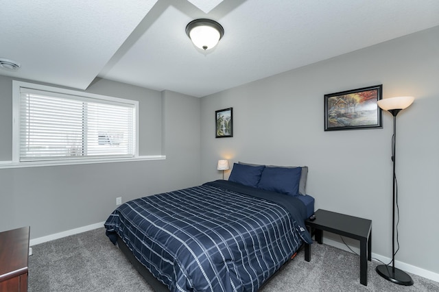 carpeted bedroom with visible vents, a textured ceiling, and baseboards