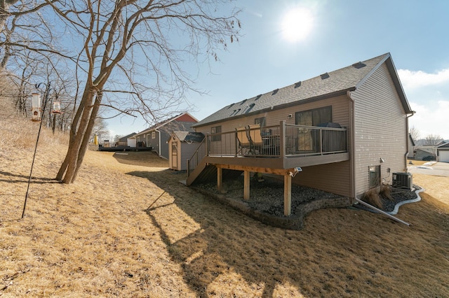 back of property with cooling unit and a deck