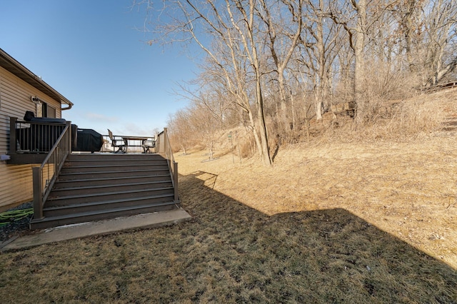 view of yard with stairs and a deck