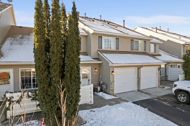 view of front of property with cooling unit and a garage