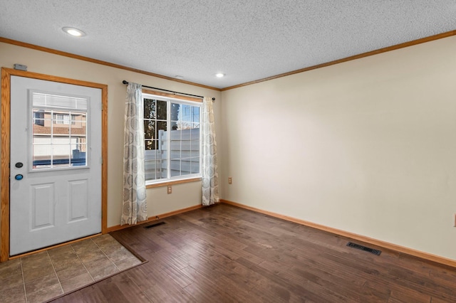 foyer entrance with crown molding, dark hardwood / wood-style floors, and a textured ceiling