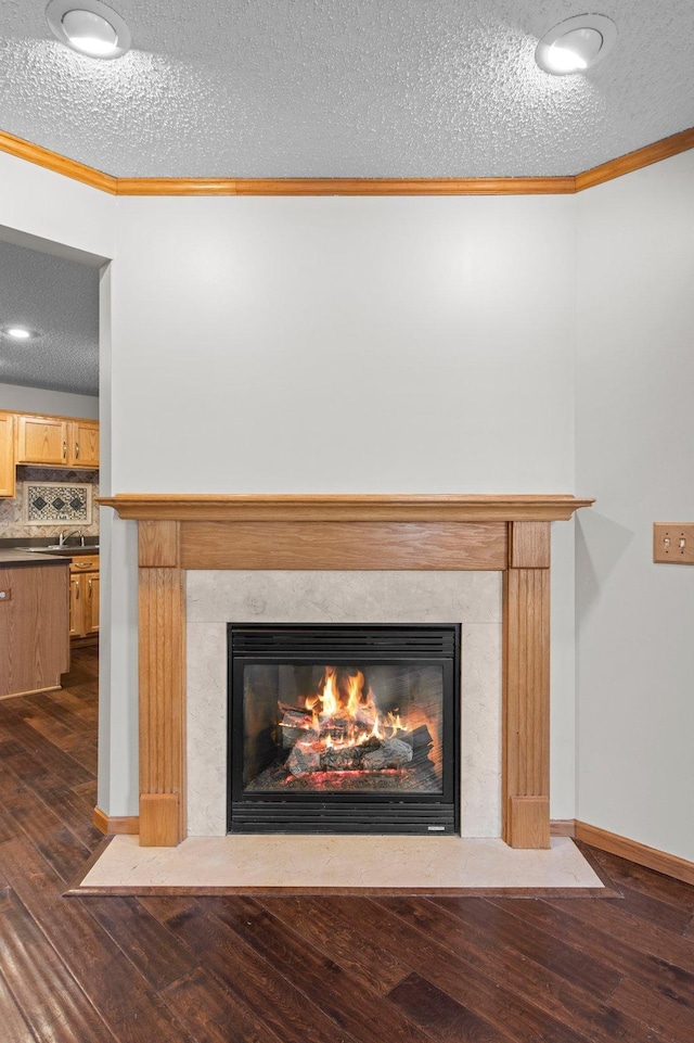 room details featuring ornamental molding, a high end fireplace, and wood-type flooring