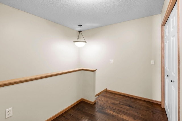 interior space with dark hardwood / wood-style flooring and a textured ceiling