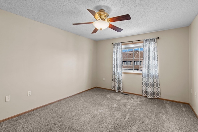 unfurnished room featuring ceiling fan, carpet floors, and a textured ceiling