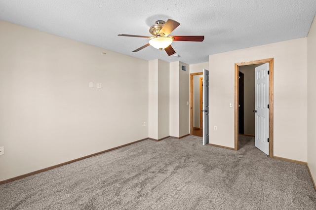 unfurnished bedroom featuring carpet flooring, a textured ceiling, and ceiling fan