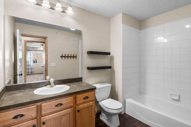 full bathroom with wood-type flooring, toilet, a textured ceiling, and vanity