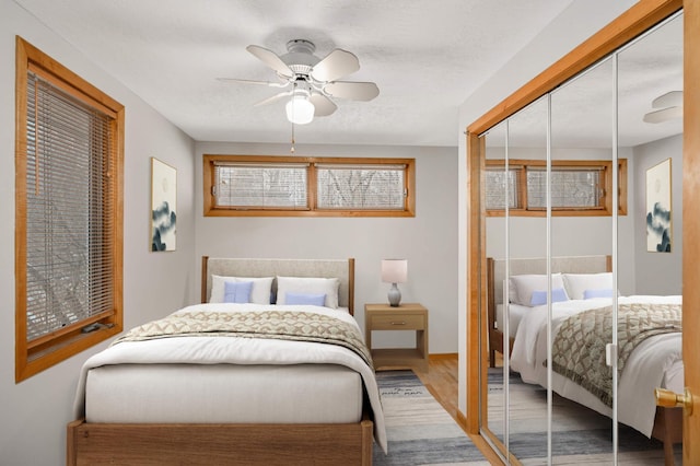 bedroom featuring hardwood / wood-style floors, a closet, and ceiling fan