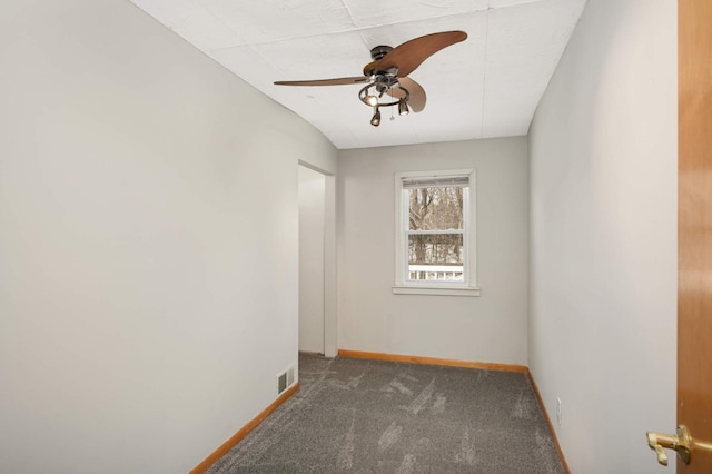 unfurnished room featuring ceiling fan and dark colored carpet