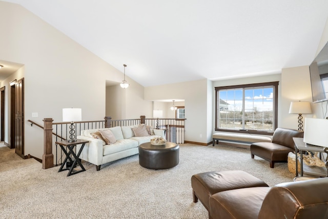 carpeted living room with high vaulted ceiling