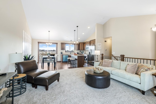 living room with a notable chandelier and high vaulted ceiling