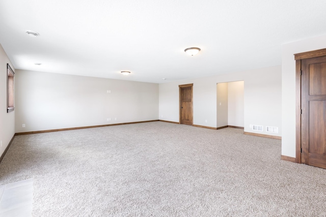 unfurnished room featuring light colored carpet