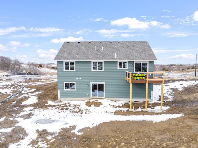 snow covered house featuring a deck