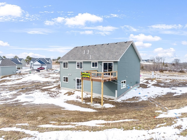 snow covered property with a wooden deck