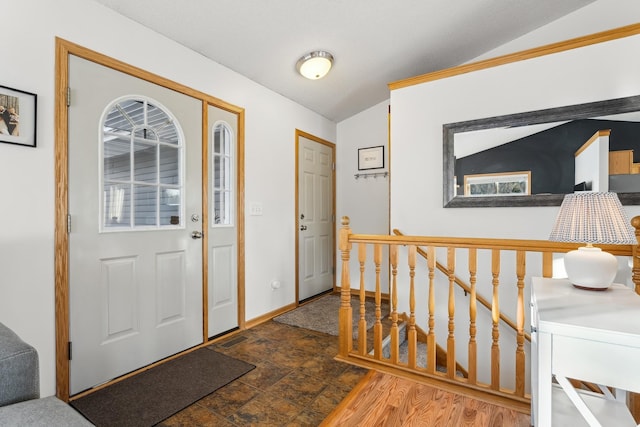 entryway with vaulted ceiling and hardwood / wood-style floors