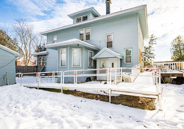 snow covered property featuring a deck