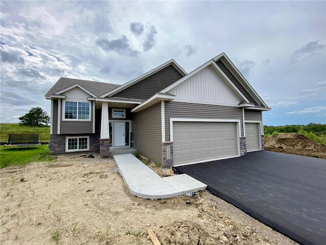 view of front of home featuring a garage and a trampoline