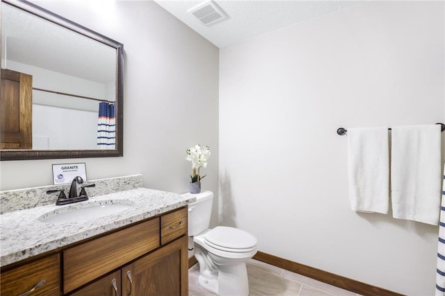 bathroom with a shower with shower curtain, vanity, toilet, and tile patterned flooring