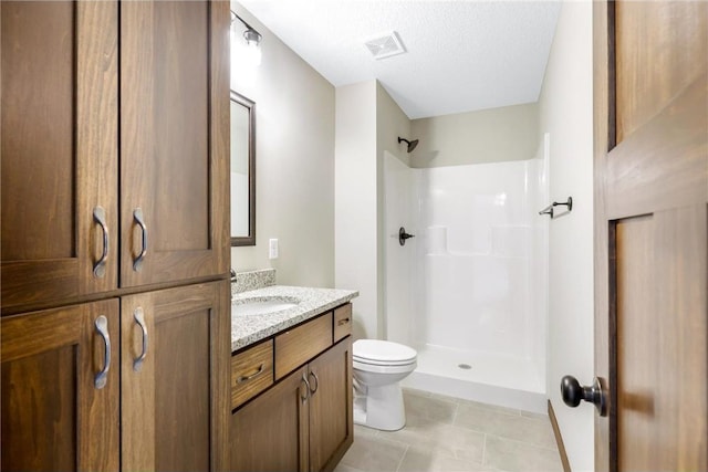 bathroom featuring a shower, tile patterned flooring, vanity, toilet, and a textured ceiling