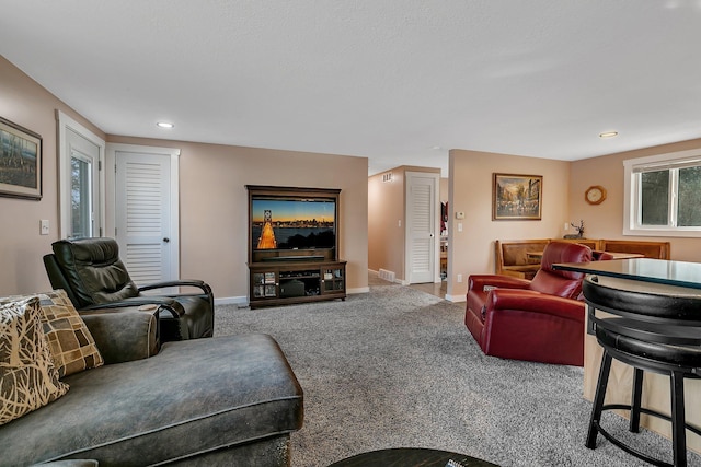 carpeted living room featuring visible vents, recessed lighting, and baseboards