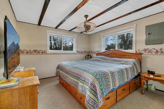 bedroom with electric panel, beam ceiling, and carpet floors