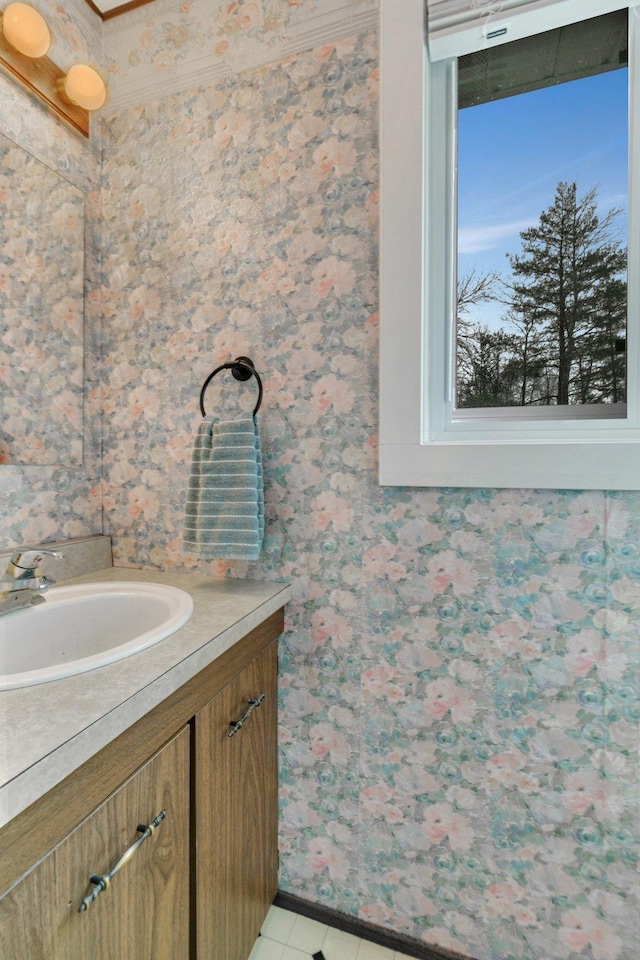 bathroom featuring tile patterned floors, wallpapered walls, and vanity