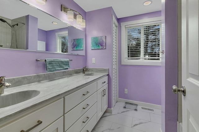 bathroom featuring baseboards, visible vents, marble finish floor, and a sink