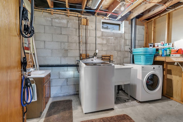 clothes washing area with washing machine and clothes dryer and laundry area