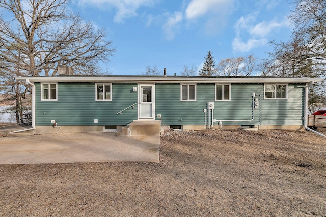 view of front of property with a patio area, a chimney, and entry steps