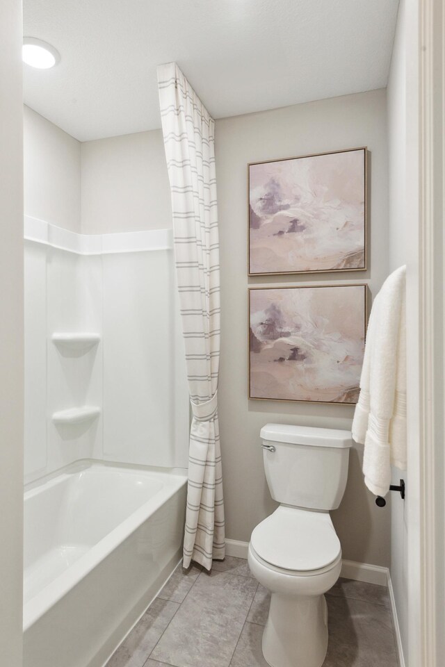 bathroom with shower / bathtub combination with curtain, tile patterned floors, and toilet