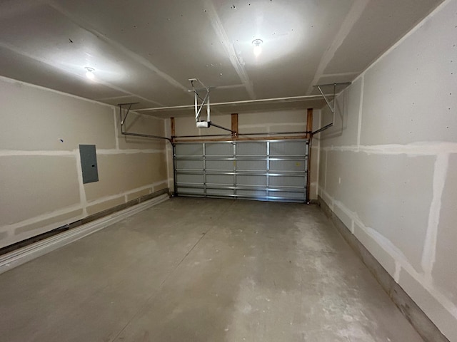 garage with a garage door opener and electric panel