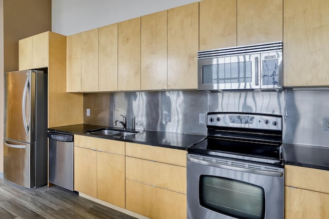 2929 Chicago Ave Unit 1216, Minneapolis, MN 55407 - kitchen featuring appliances with stainless steel finishes, light brown cabinetry, backsplash, dark wood finished floors, and dark countertops