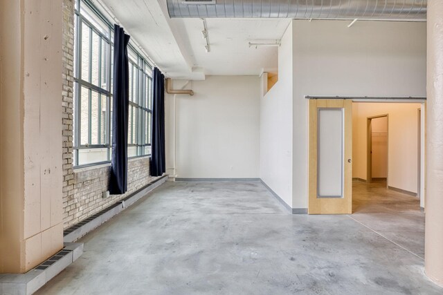 2929 Chicago Ave Unit 1216, Minneapolis, MN 55407 - spare room with concrete flooring and rail lighting