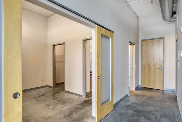 2929 Chicago Ave Unit 1216, Minneapolis, MN 55407 - hall featuring concrete flooring and a high ceiling
