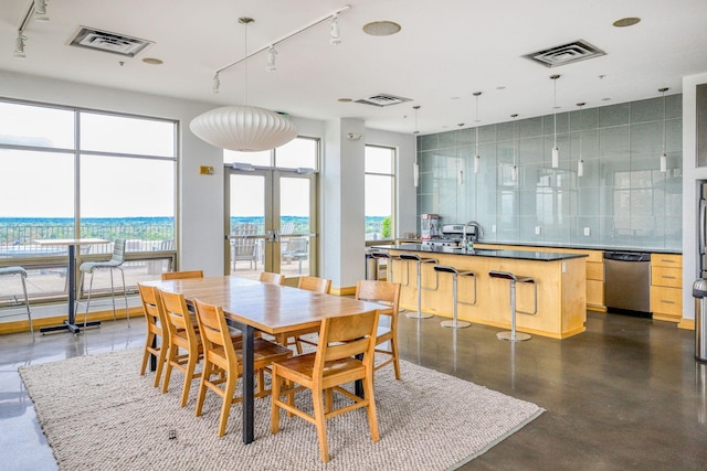 2929 Chicago Ave Unit 1216, Minneapolis, MN 55407 - dining area featuring rail lighting, french doors, and concrete flooring