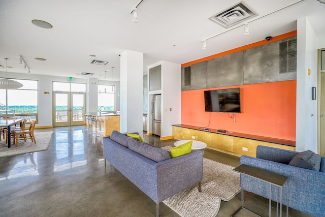 2929 Chicago Ave Unit 1216, Minneapolis, MN 55407 - living room with track lighting and finished concrete flooring