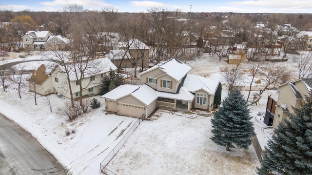 snowy aerial view featuring a residential view