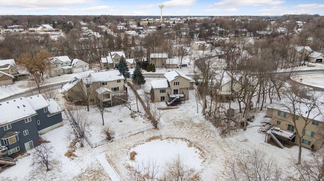 snowy aerial view with a residential view